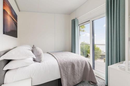 a bedroom with a bed and a large window at Upper Cliff Studio in Portland