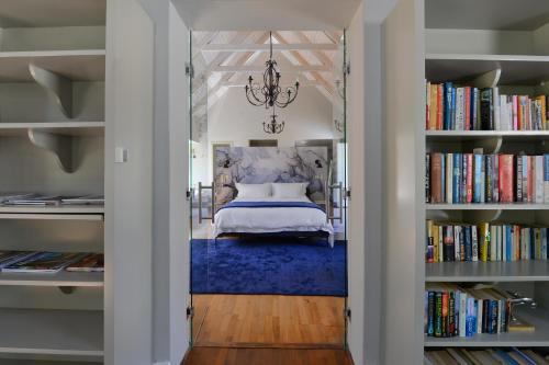 a bedroom with a bed and books at Fransvliet Guest House in Franschhoek