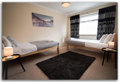 Voodi või voodid majutusasutuse Lovely 3 bed Abode - Sleeps 5 toas