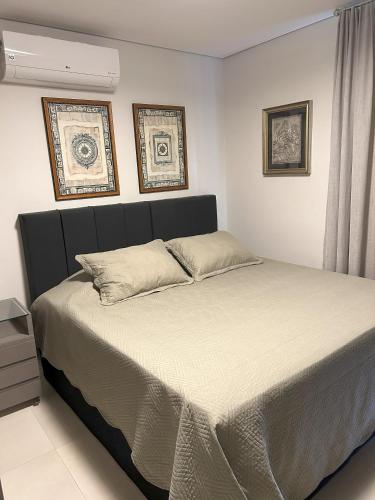 a bedroom with a large bed with two pillows at Requinte e Conforto OP - MG in Ouro Preto