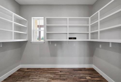 an empty room with white shelves and a window at New Luxury Texas Farmhouse in Bellmead