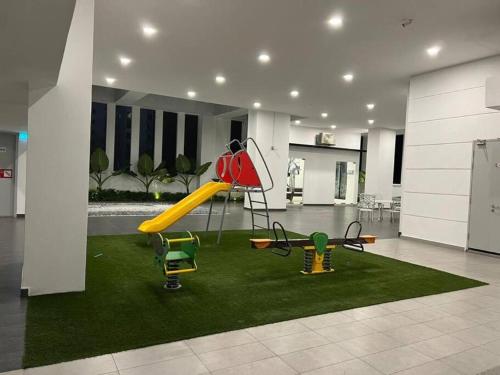 a room with a playground with a slide at HomeFeel Netflix Youtube Free WiFi and Parking - MSuite at Bandar Manjalara, Near to DesaPark, Arkadia, One Utama, Kepong, Sri Damansara, Kota Damansara, Kuala Lumpur in Kuala Lumpur