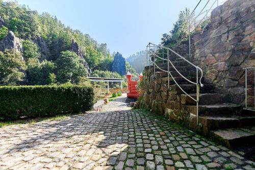 a red truck is driving down a stone road at Apartmány Svatošské skály in Loket