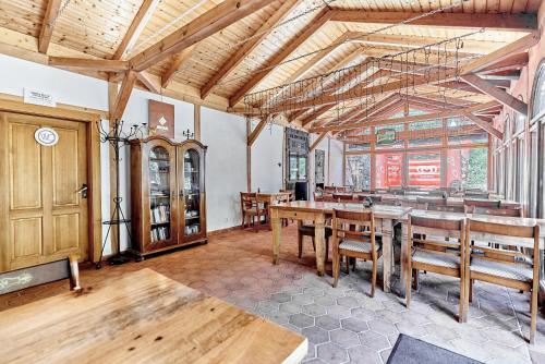 a dining room with wooden tables and wooden chairs at Apartmány Svatošské skály in Loket