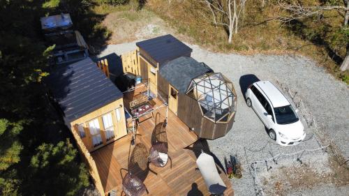 an aerial view of a house with a van parked outside at Fuji Dome Glamping in Fujikawaguchiko