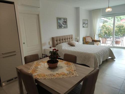 a bedroom with a bed and a table and chairs at La Casa degli Ulivi in Chiavari