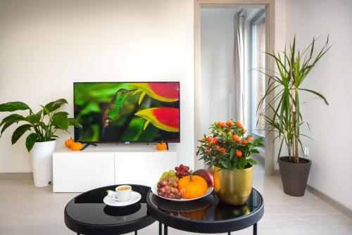 a living room with a table with fruit on it at Maya's Apartments in Gdańsk