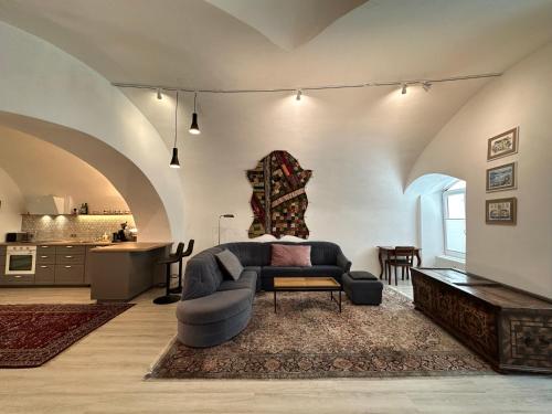 a living room with a couch and a table at exquisit home in historic vault in Gmunden