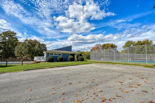 an empty road in front of a house with a fence at Orr at Waterways in Huddleston