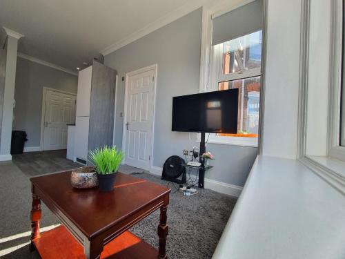 a living room with a table and a flat screen tv at Beautiful Maidstone Gem - Sleeps 2 in Kent