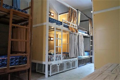 a room with several bunk beds in a room at Bali Bobo Hostel in Jimbaran