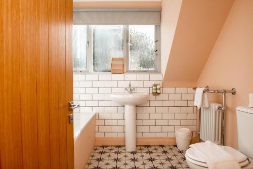 a bathroom with a sink and a toilet at Cameo Cottage 