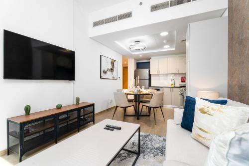 a living room with a couch and a table at Nasma Luxury Stays - Home-Style 2BR Apartment with a Balcony View in Dubai