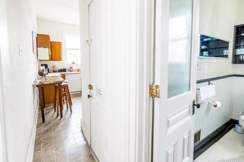 a white door leading into a kitchen with a table at Step Back in Time Charming Victorian with Modern Amenities in Homestead