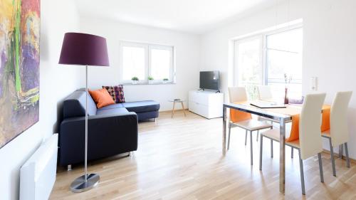 a living room with a table and chairs and a couch at Apartments Jesse in Sankt Kanzian