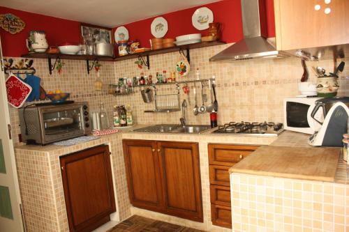a kitchen with a sink and a stove top oven at Casa Vacanza Da Andrea in Naples