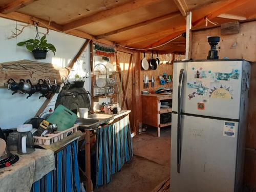 a kitchen with a refrigerator and a counter top at COSMOS nature Lodge and Spiritual community in Dahab