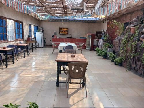 a restaurant with tables and chairs in a room at New Palace Hotel in Cairo