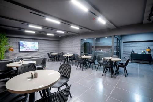 a restaurant with tables and chairs in a room at Hotel Best Tbilisi in Tbilisi City