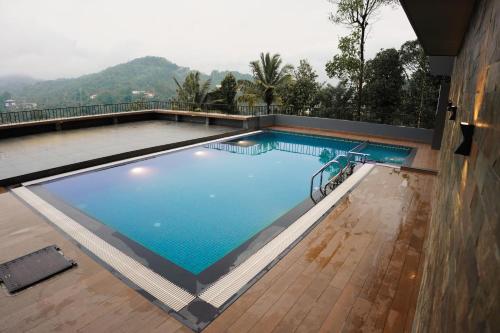 a large swimming pool on top of a building at Leaves Resort Vythiri Wayanad in Vythiri
