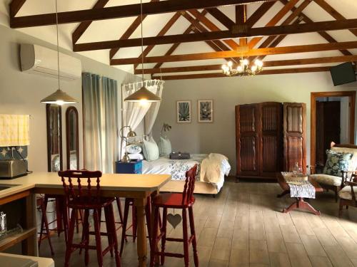 a kitchen and living room with a bed and a table at Lentelus Guesthouse in George