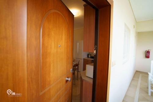 a hallway with a wooden door in a kitchen at 'On The Wave' With Amazing View in Faraí