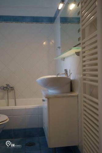 a bathroom with a sink and a toilet and a tub at 'On The Wave' With Amazing View in Faraí