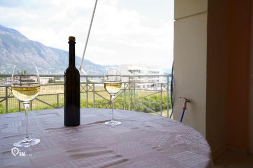 a bottle of wine and two glasses on a table at 'On The Wave' With Amazing View in Faraí