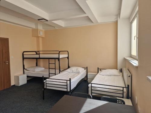 Habitación con 2 literas y mesa. en HOSTEL PARK-Dobraszczecińska en Szczecińska