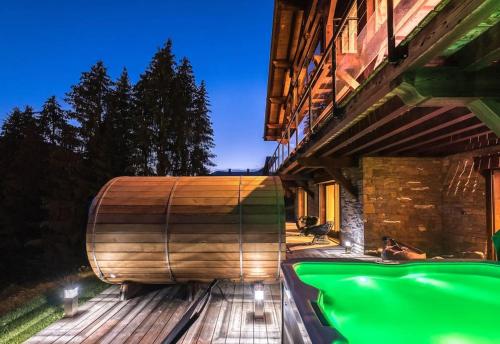 a large wooden boat on the side of a building at Chalet Familial Spacieux Le Spencer Grand Luxe Châtel in Châtel