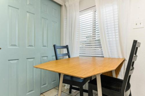 a dining room with a wooden table and two chairs at Sea Haven Motel Unit 2. in Rockaway Beach