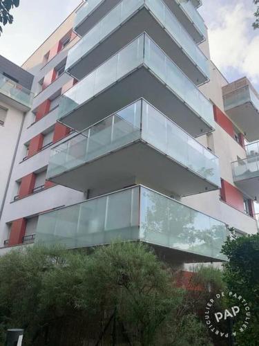 un grand bâtiment avec des balcons en verre sur son côté dans l'établissement studio récent de 39 m2 meublé, à Créteil