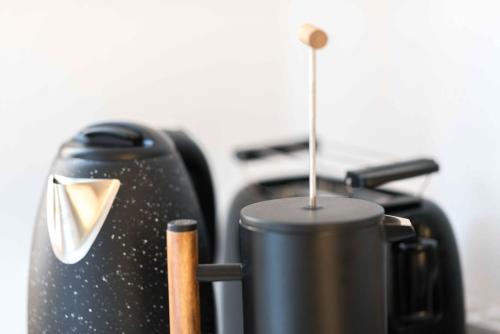 a coffee pot sitting on a stove with a straw at Im alten Kino in Fehrenbach