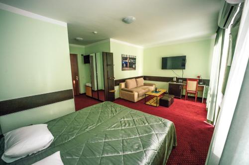 a hotel room with a bed and a living room at Autopapa in Rustavi