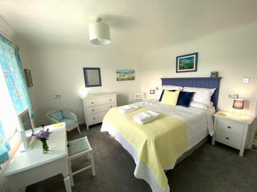 a bedroom with a large bed with a blue headboard at Fields View in Newbridge