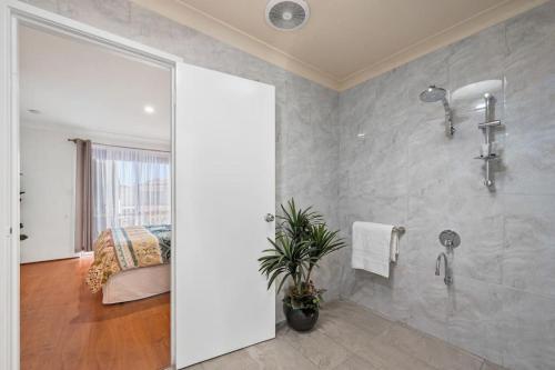 a bathroom with a shower and a toilet in a room at Magnolia Sea Views in Mandurah