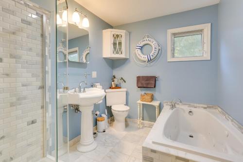 a bathroom with a tub and a sink and a toilet at Narrowsburg Home with Backyard Near Delaware River! in Narrowsburg