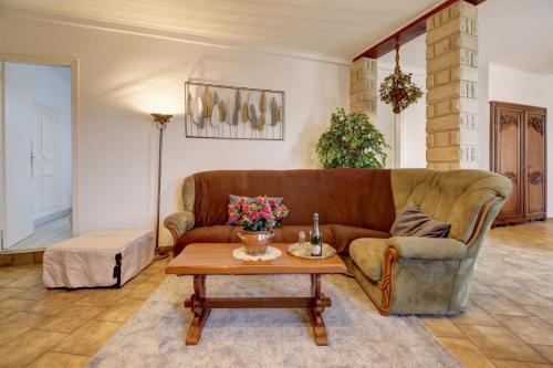a living room with a couch and a coffee table at Le Relais Champenois in Fagnières