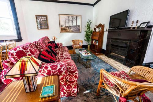 a living room with a couch and a fireplace at Parkside Paradise Elegant Victorian Home Just Steps from the Park in Homestead