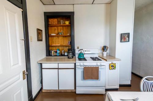 a kitchen with a white stove and a counter top at Parkside Paradise Elegant Victorian Home Just Steps from the Park in Homestead