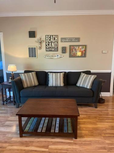 a living room with a blue couch and a coffee table at Tranquil 3BR Condo in Magnolia Pointe near Myrtlewood Golf Resort in Myrtle Beach