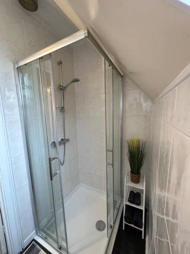a shower with a glass door in a bathroom at Cosy Stay in the Heart of Dover in Kent
