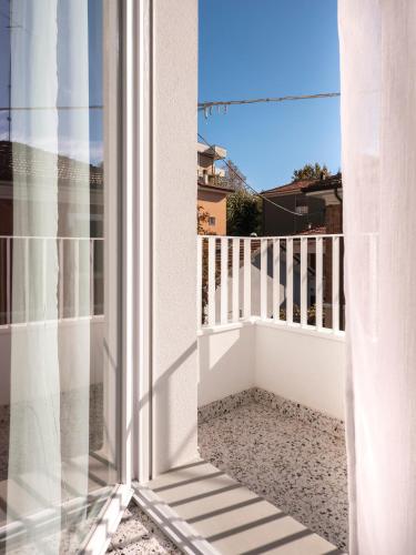 an open window with a view of a balcony at Zuara9Room Rimini in Rimini