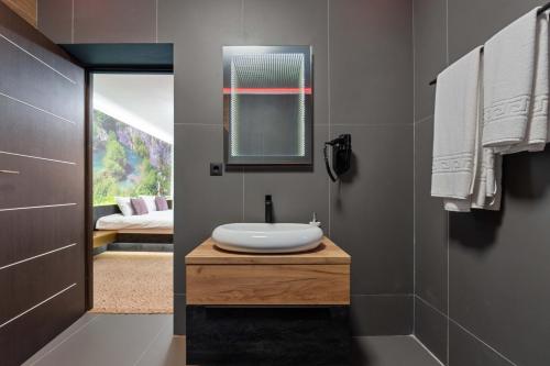 a bathroom with a sink and a mirror at Fit Residence in Cluj-Napoca