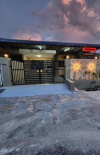a house with a garage with a driveway at Sun Star Home by Ipoh Maju Stay in Ipoh