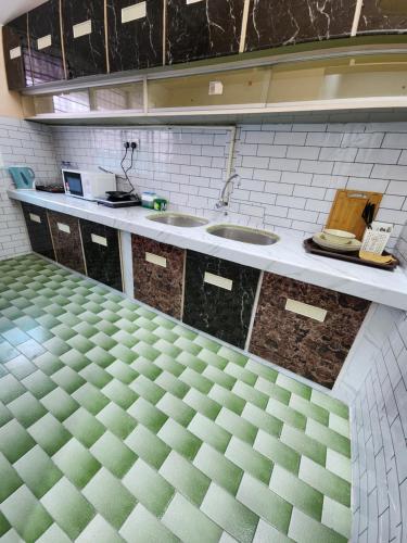 a kitchen with two sinks and a counter at Sun Star Home by Ipoh Maju Stay in Ipoh