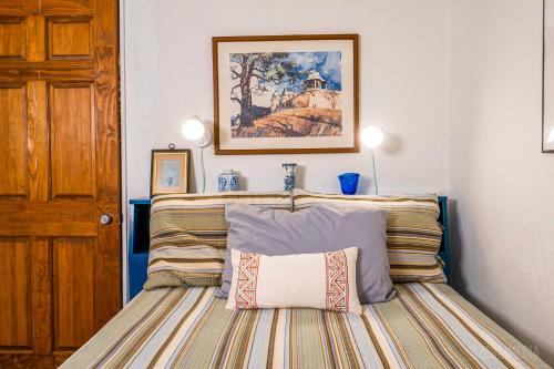 a bedroom with a bed with a framed picture on the wall at The Bridges Mt Washington Sleeps 12 in Pittsburgh