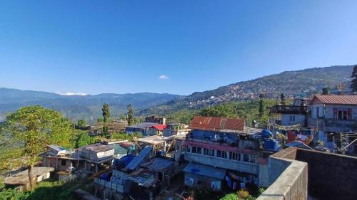an aerial view of a village in the mountains at Aama Home Stay in Kurseong