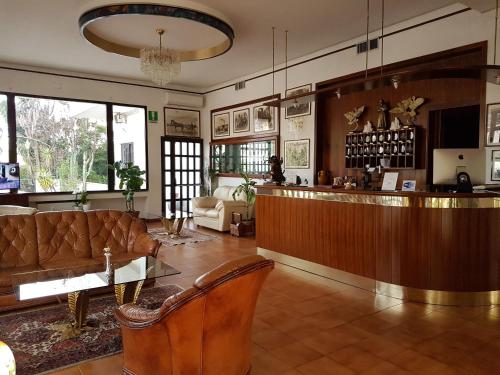 a lobby with a bar with a couch and a table at Hotel Calla' in Policoro