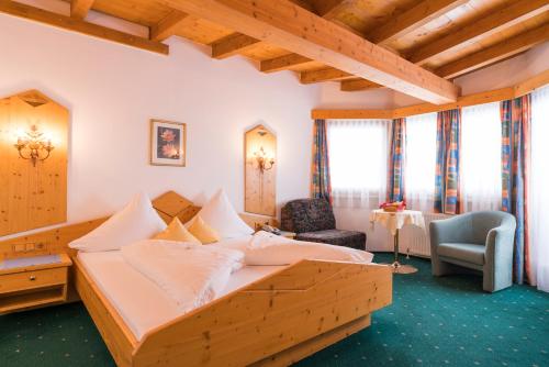 a bedroom with a wooden bed in a room at Bergsporthotel Antonie in Gries im Sellrain